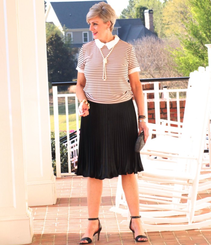 karl lagerfeld striped blouse black pleated skirt, black sandals, clutch