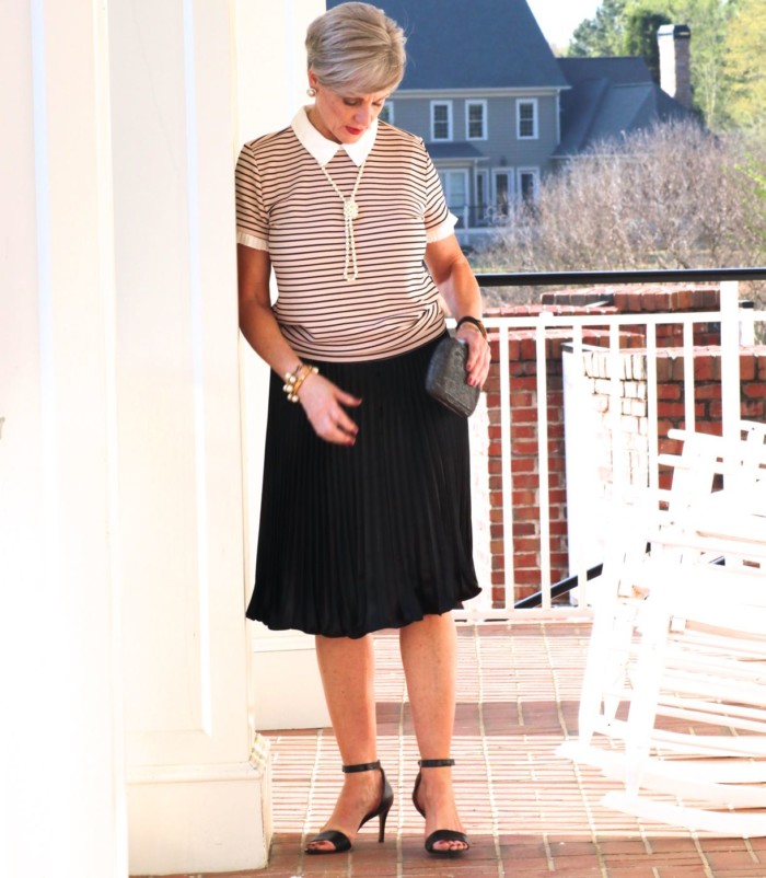 karl lagerfeld striped blouse black pleated skirt, black sandals, clutch