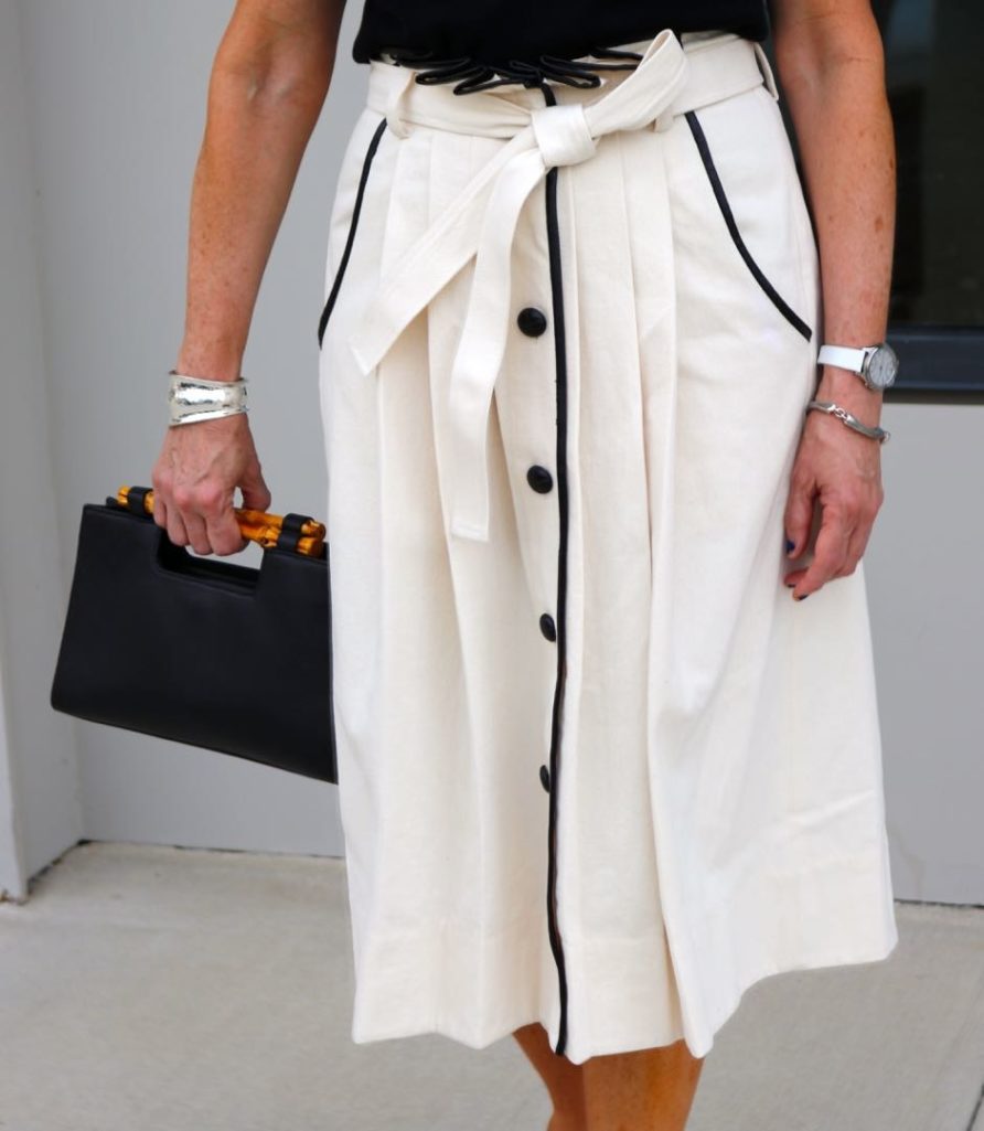 pleated cone denim skirt, black sleeveless turtleneck,