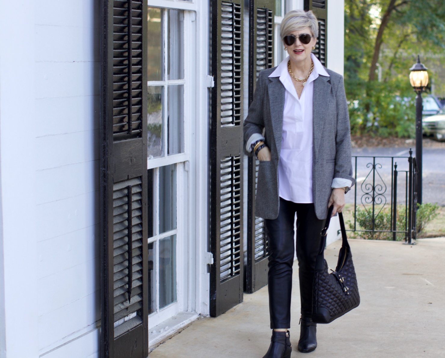 beth at Style at a Certain Age wears faux leather leggings, white shirt, boyfriend blazer, and black booties