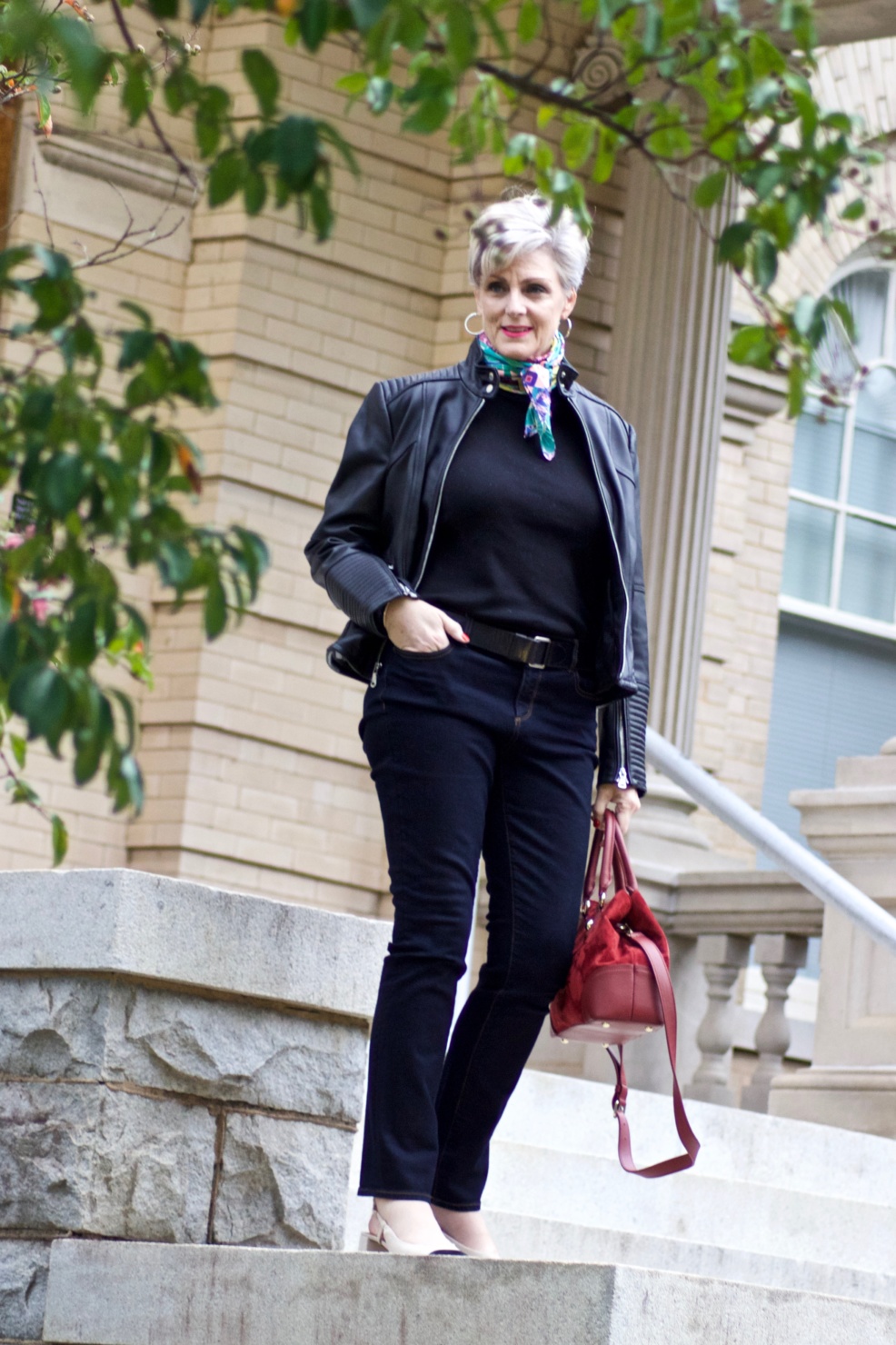 leather moto jacket, black sweater, silk scarf, statement handbag