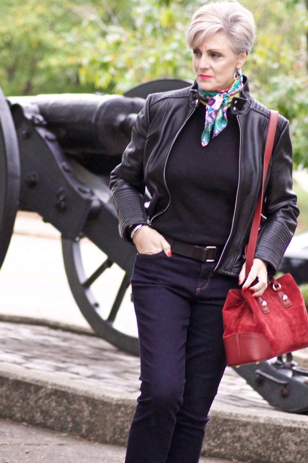 leather moto jacket, black sweater, silk scarf, statement handbag