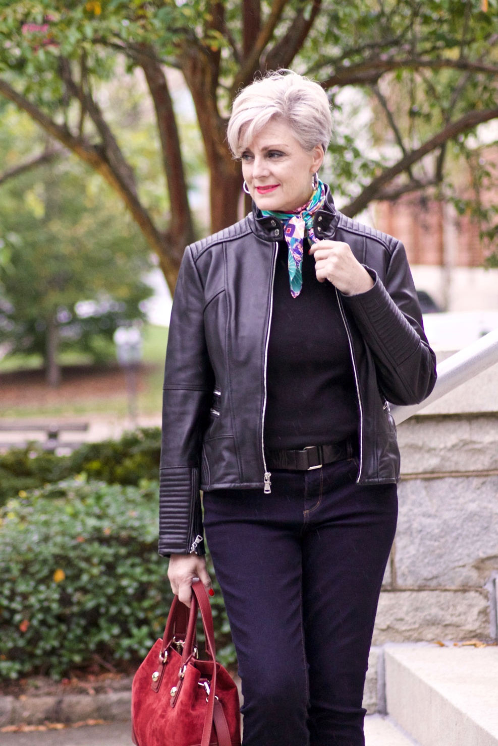 leather moto jacket, black sweater, silk scarf, statement handbag