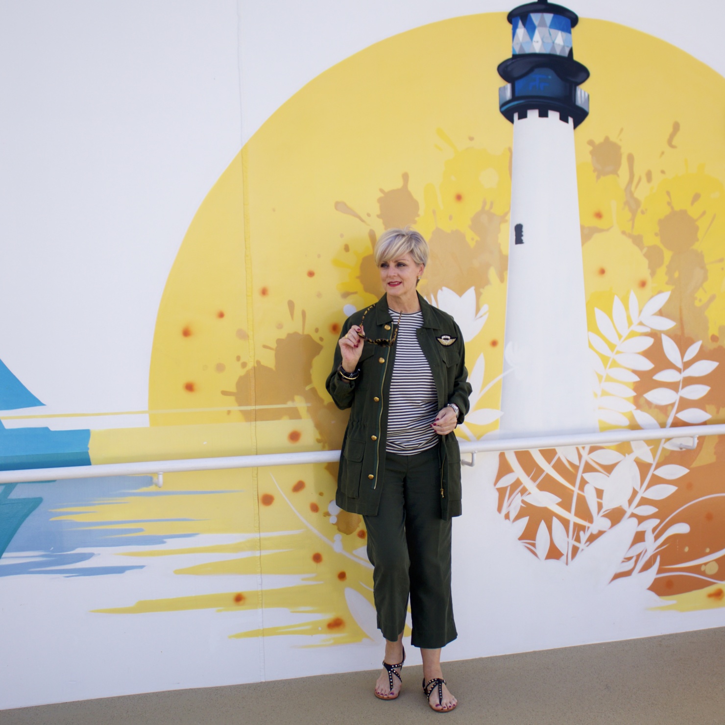 beth from Style at a Certain Age wears a Ralph Lauren military jacket, striped tee, and green cropped pants