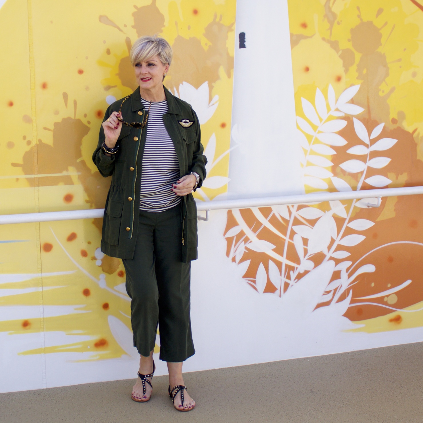 beth from Style at a Certain Age wears a Ralph Lauren military jacket, striped tee, and green cropped pants