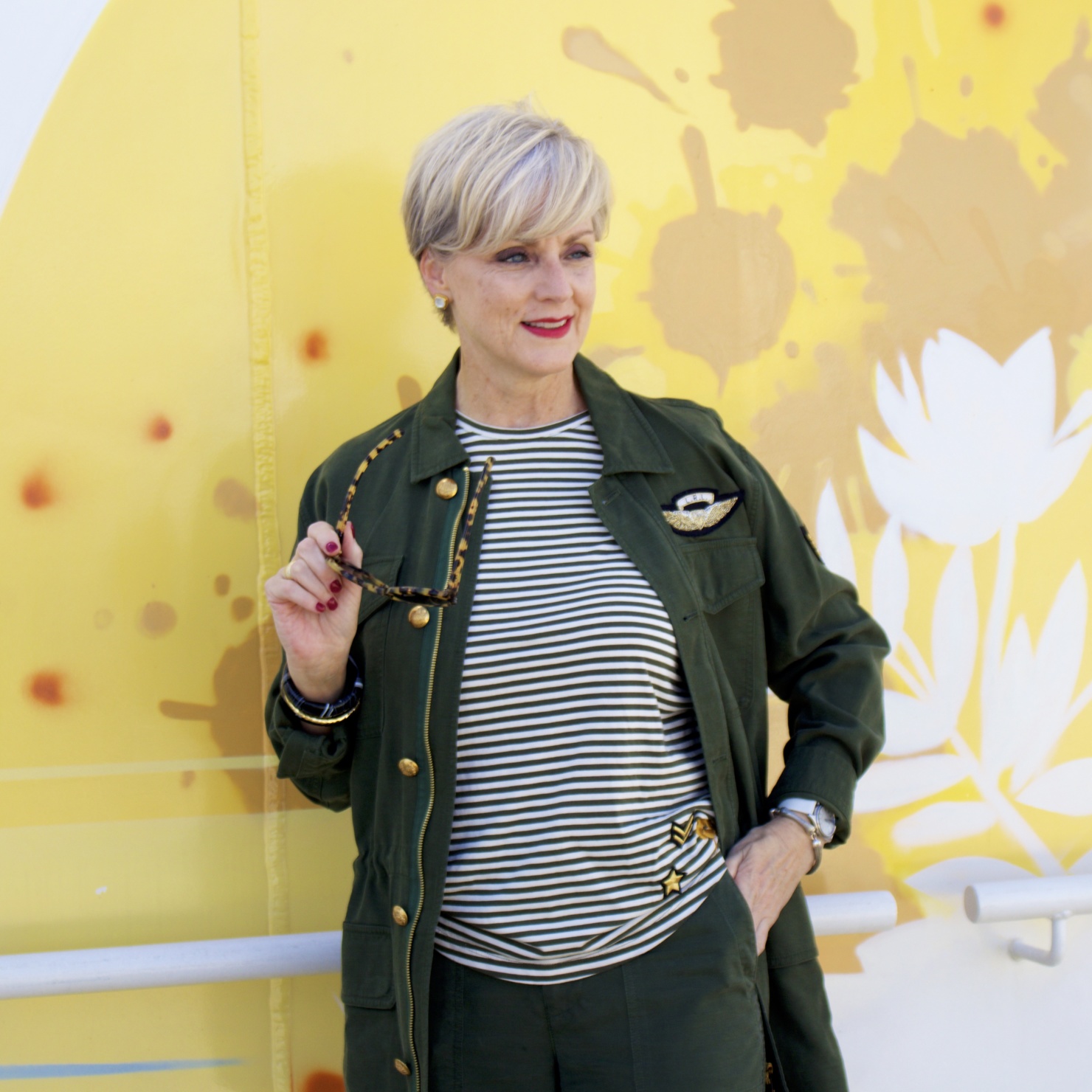 beth from Style at a Certain Age wears a Ralph Lauren military jacket, striped tee, and green cropped pants