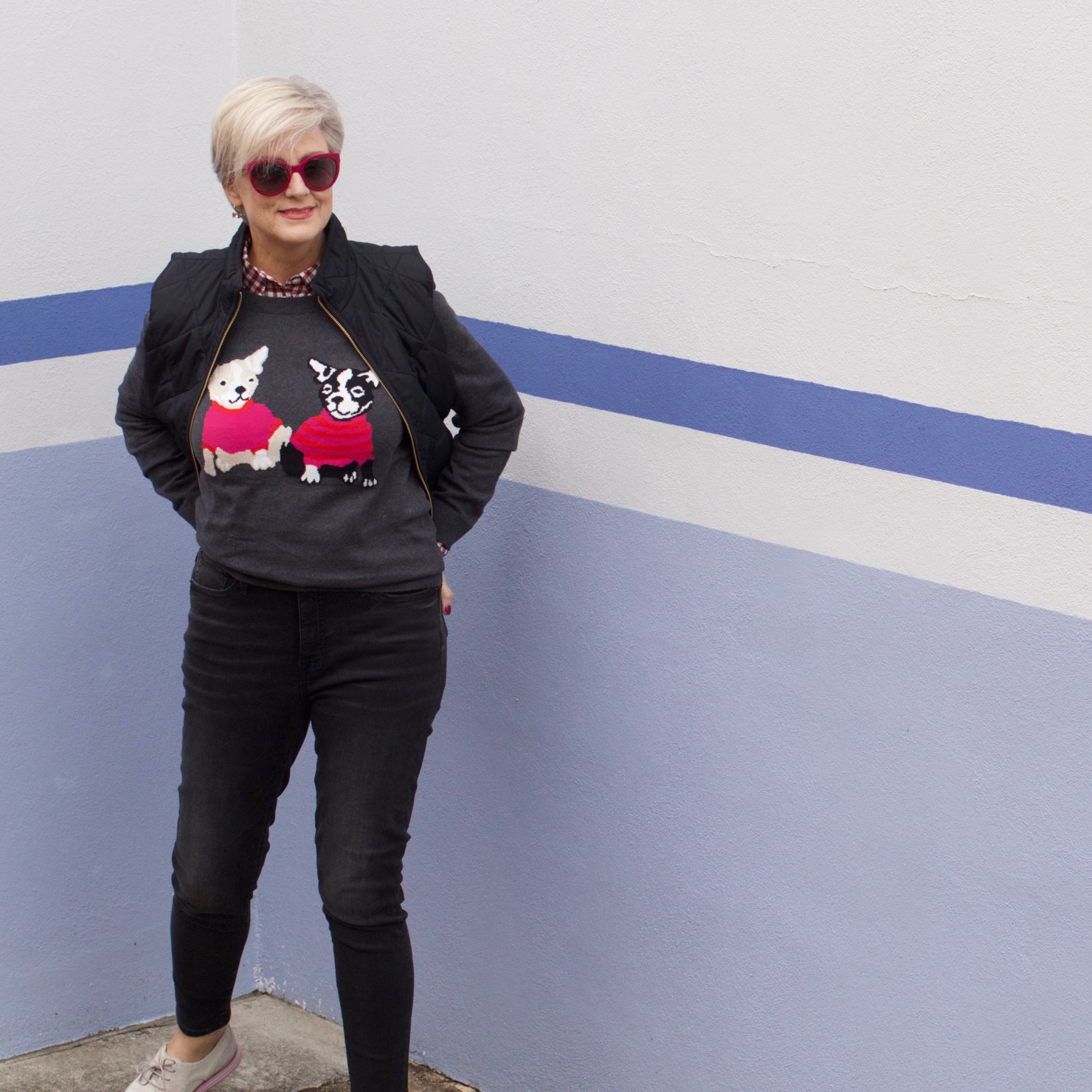 beth from Style at a Certain Age wears a J.Crew Factory high rise skinny jean, burgundy check shirt, french bulldog teddie sweater, quilted puffer jacket