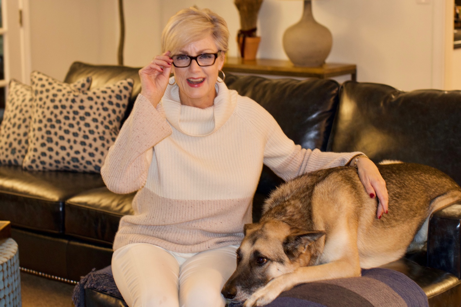beth from Style at a Certain Age wears a cashmere color block sweater, slim leg ivory pants, cap toe ballet flats