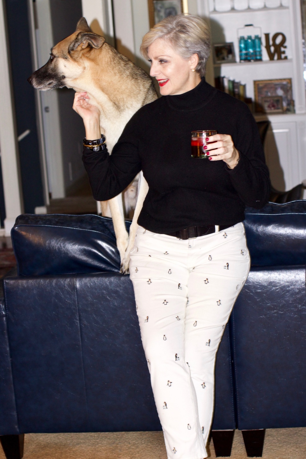 beth from Style at a Certain Age wears a black cashmere turtleneck, embroidered corduroys, and knit blazer