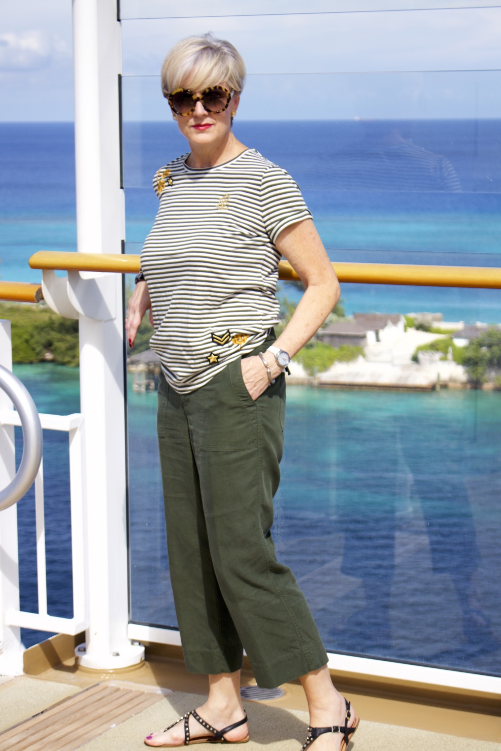 beth from Style at a Certain Age wears a Ralph Lauren military jacket, striped tee, and green cropped pants