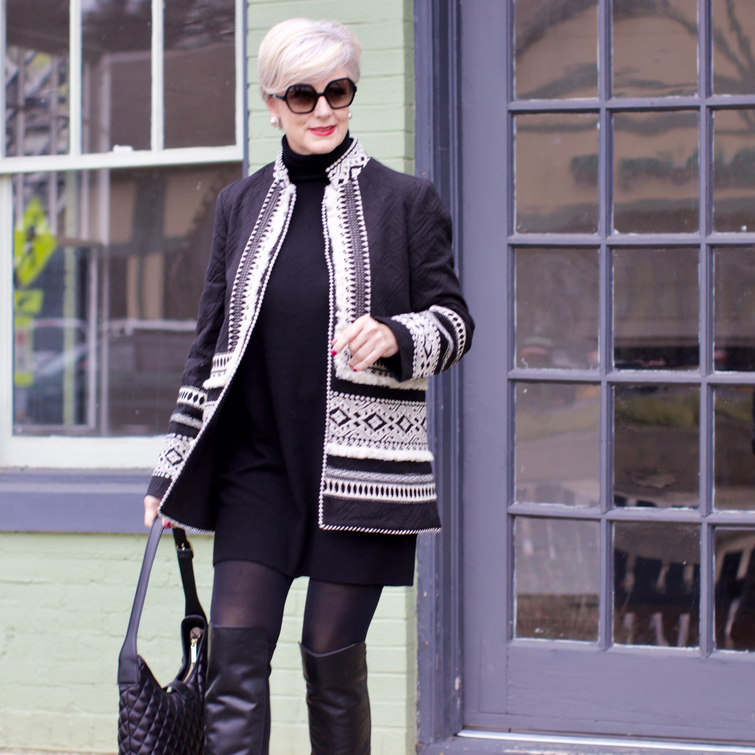 beth from style at a certain age wears a monochromatic outfit cashmere sweater dress from everlane, anthropologie embroidered jacket, black over the knee boots