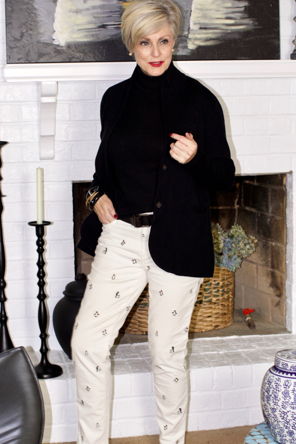 beth from Style at a Certain Age wears a black cashmere turtleneck, embroidered corduroys, and knit blazer