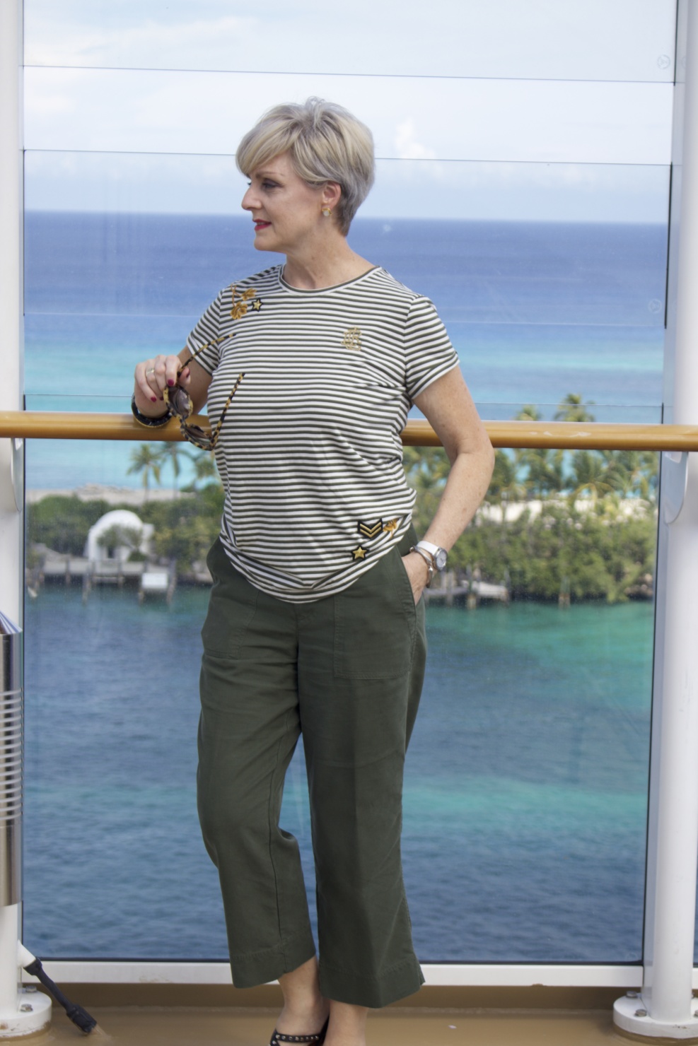 beth from Style at a Certain Age wears a Ralph Lauren military jacket, striped tee, and green cropped pants