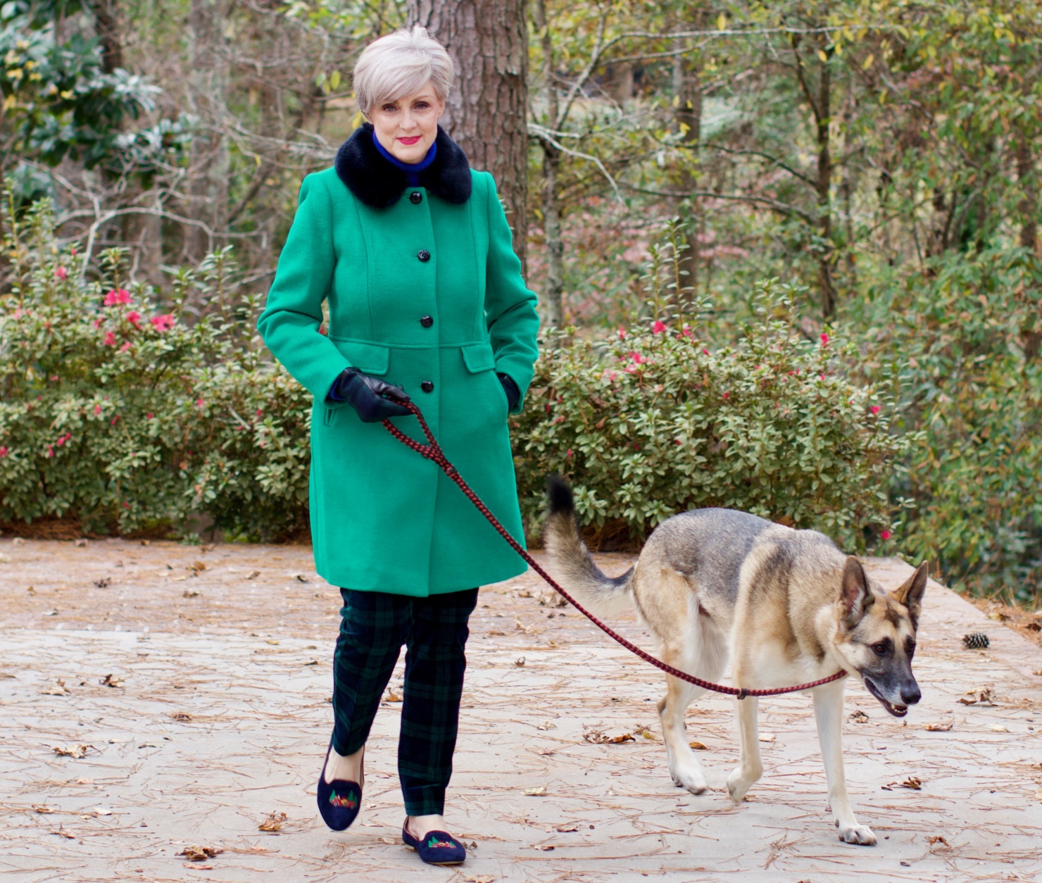 beth from Style at a Certain age wears velveteen black watch plaid pants, blue ribbed turtleneck, and loafers