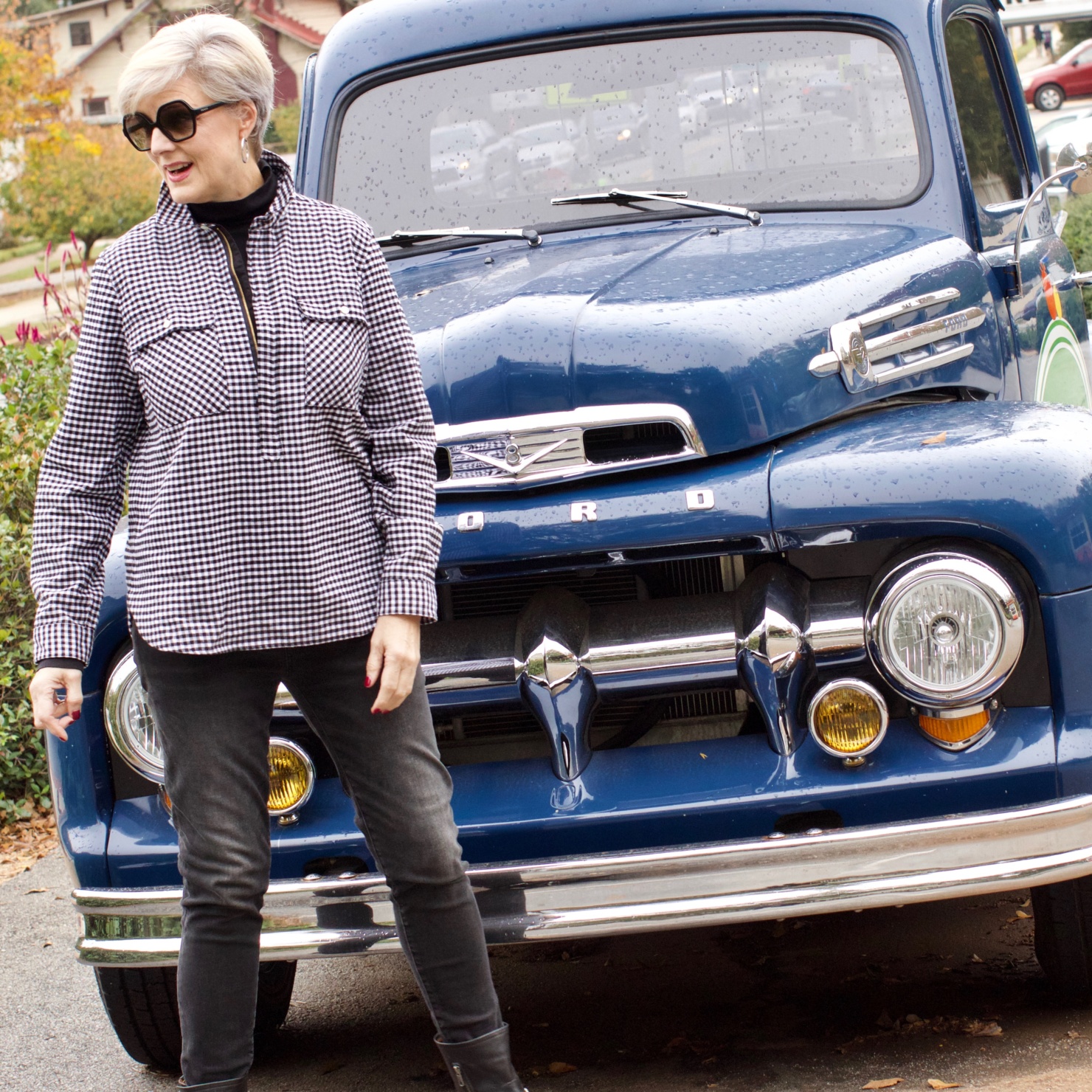 beth from style at a certain age wears high rise skinny jeans, tissue turtleneck, gingham shirt jacket, and puffer vest