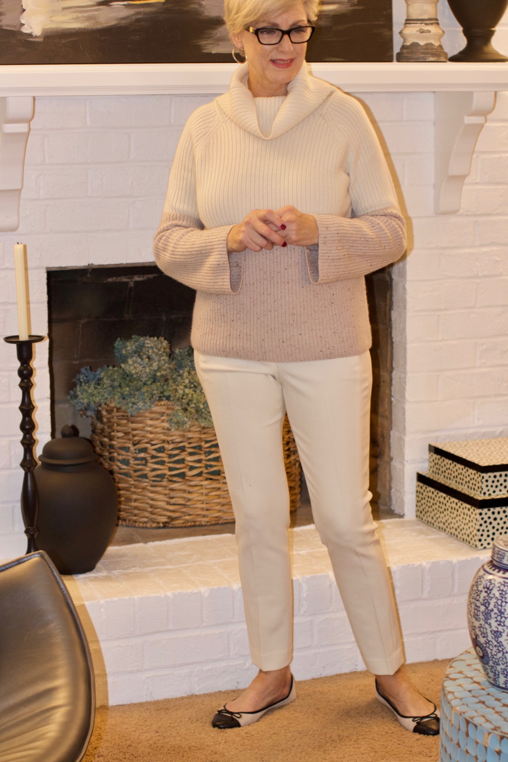 beth from Style at a Certain Age wears a cashmere color block sweater, slim leg ivory pants, cap toe ballet flats