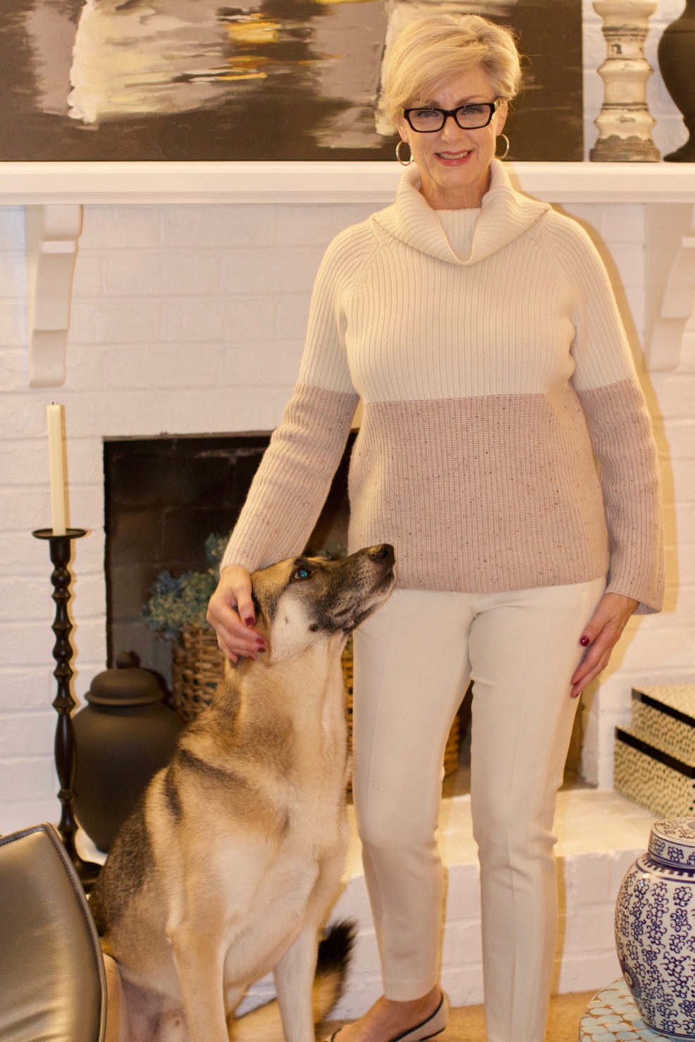 beth from Style at a Certain Age wears a cashmere color block sweater, slim leg ivory pants, cap toe ballet flats
