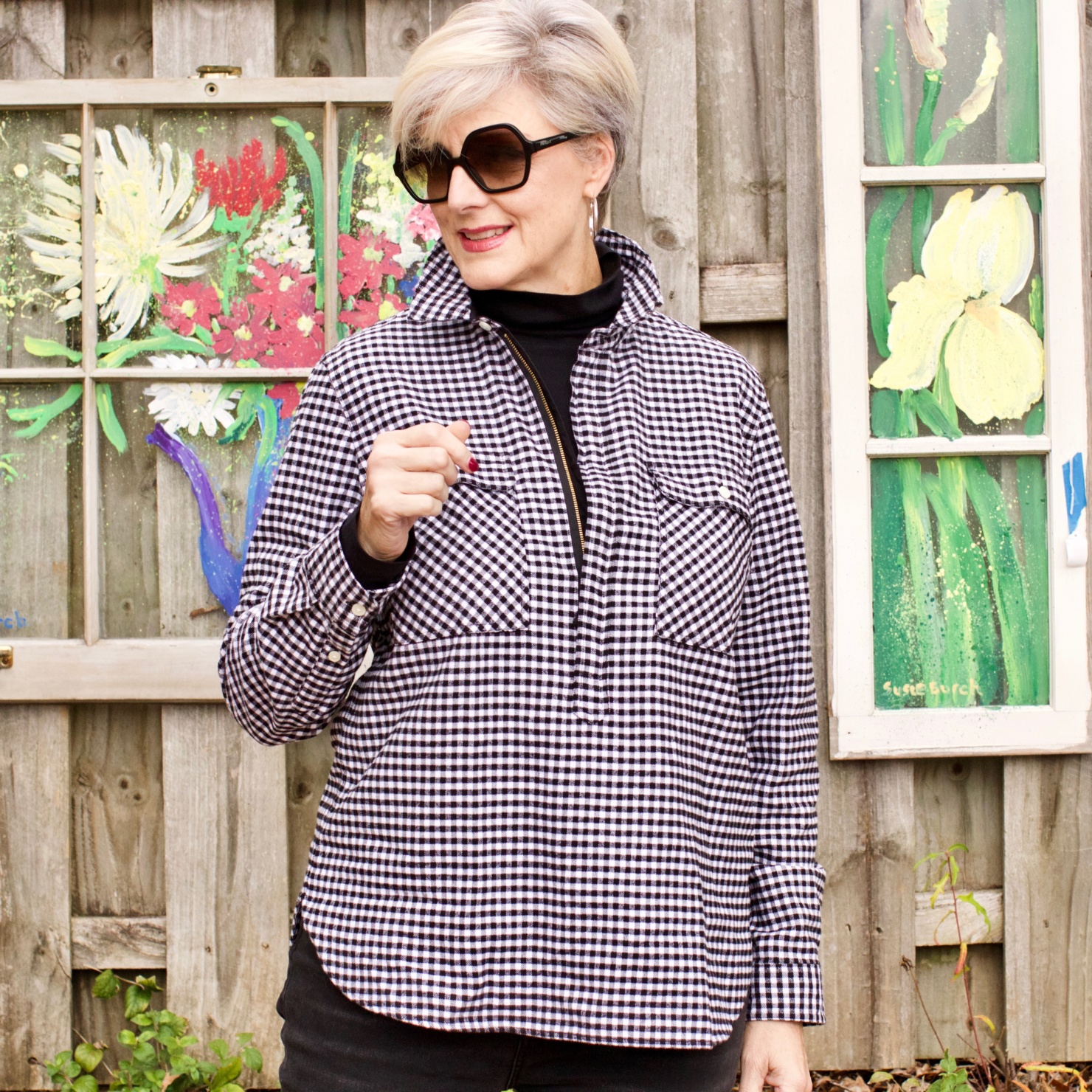 beth from style at a certain age wears high rise skinny jeans, tissue turtleneck, gingham shirt jacket, and puffer vest