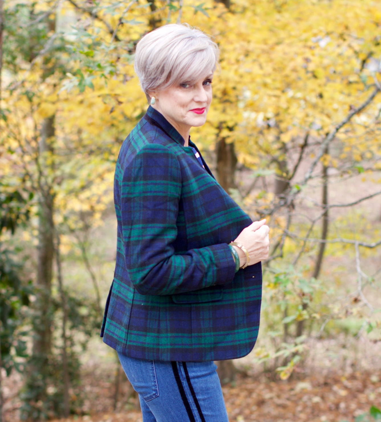beth from Style at a Certain age wears velveteen black watch plaid pants, blue ribbed turtleneck, and loafers