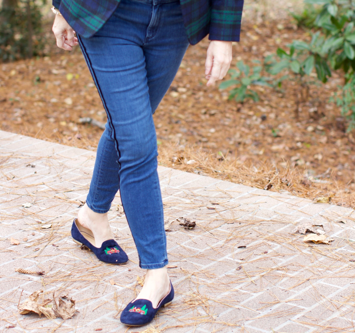 beth from Style at a Certain age wears velveteen black watch plaid pants, blue ribbed turtleneck, and loafers
