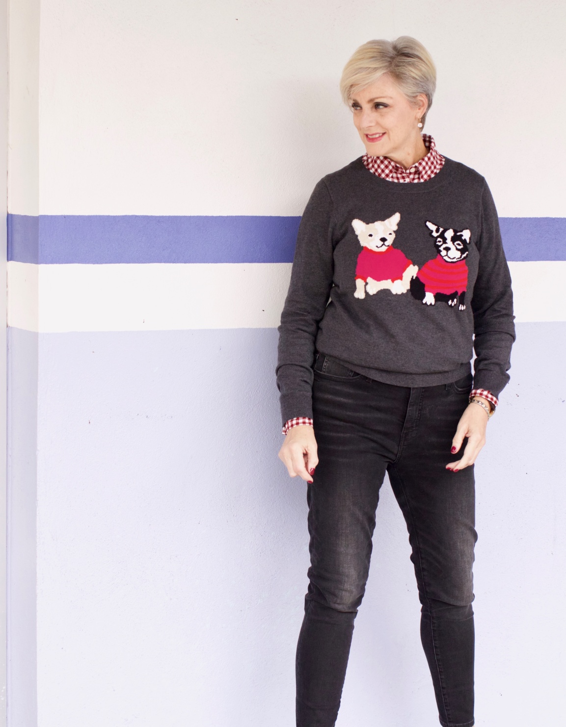 beth from Style at a Certain Age wears a J.Crew Factory high rise skinny jean, burgundy check shirt, french bulldog teddie sweater, quilted puffer jacket