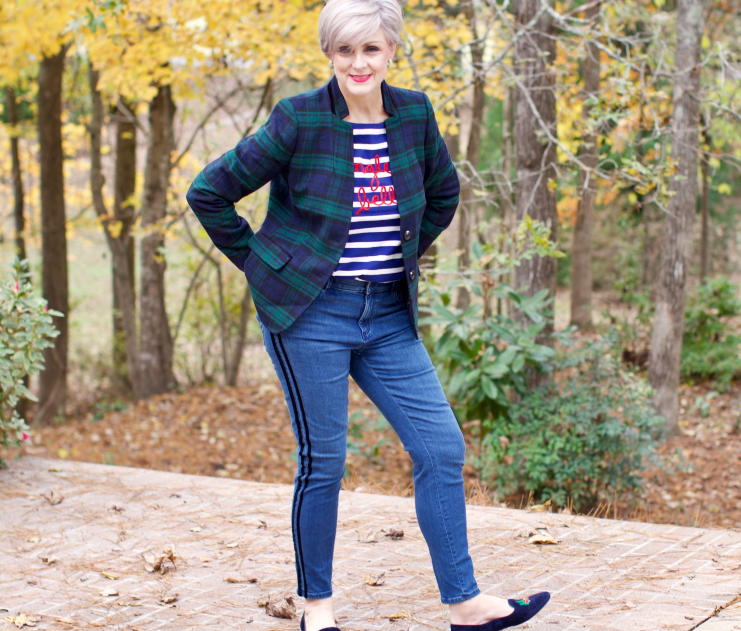 beth from Style at a Certain age wears velveteen black watch plaid pants, blue ribbed turtleneck, and loafers