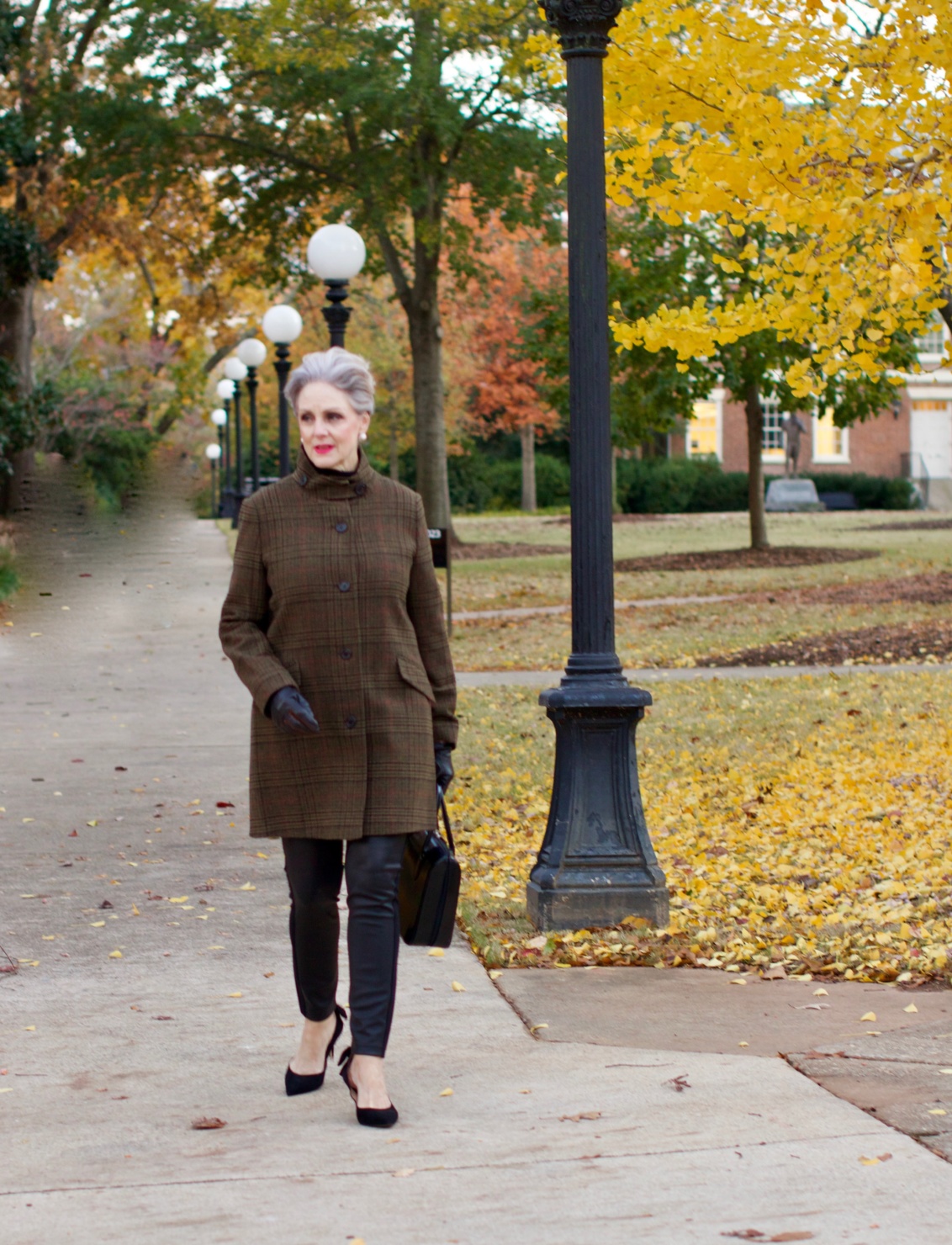 beth from Style at a Certain Age wears a black cashmere Turtleneck dress, faux leather leggings and suede pumps.