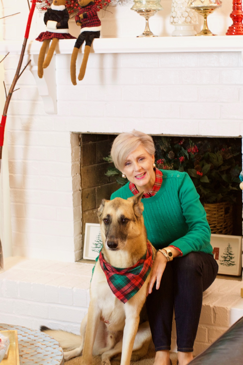 beth from Style at a Certain Age wears a cable knit sweater and plaid shirt dark rinse blue jeans