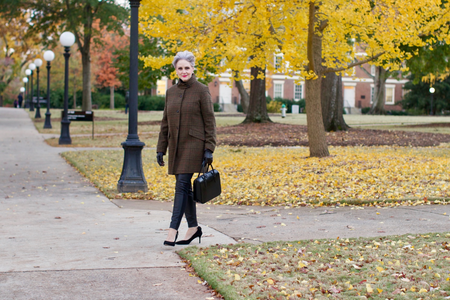 beth from Style at a Certain Age wears a black cashmere Turtleneck dress, faux leather leggings and suede pumps.