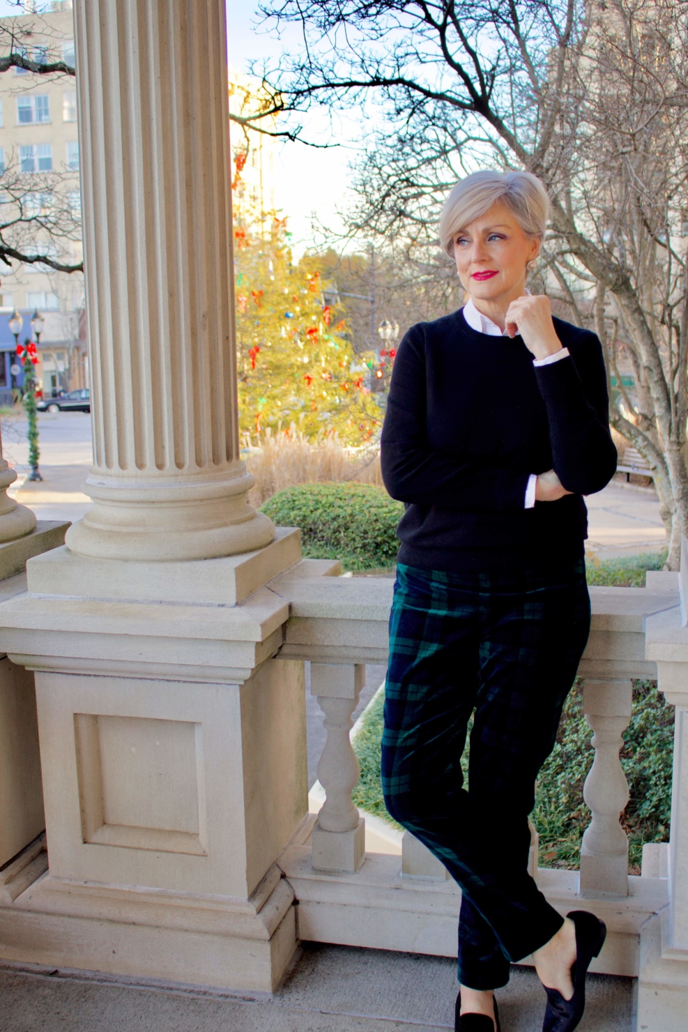 beth from Style at a Certain Age wears a black cashmere crewneck and black watch plaid ankle pants