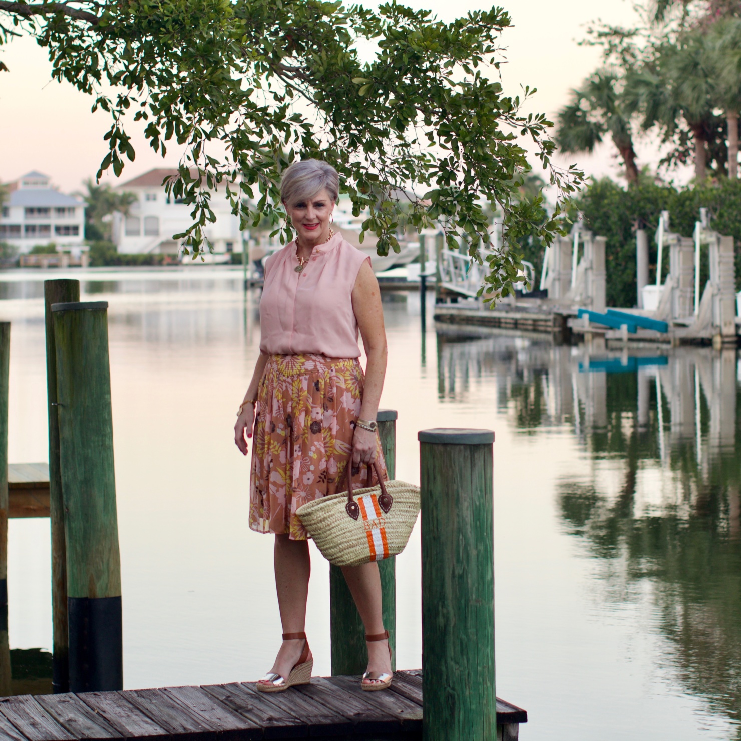 beth from Style at a Certain Age wears a Tory Burch silk blow blouse, silk skirt, and Tory Burch wedges
