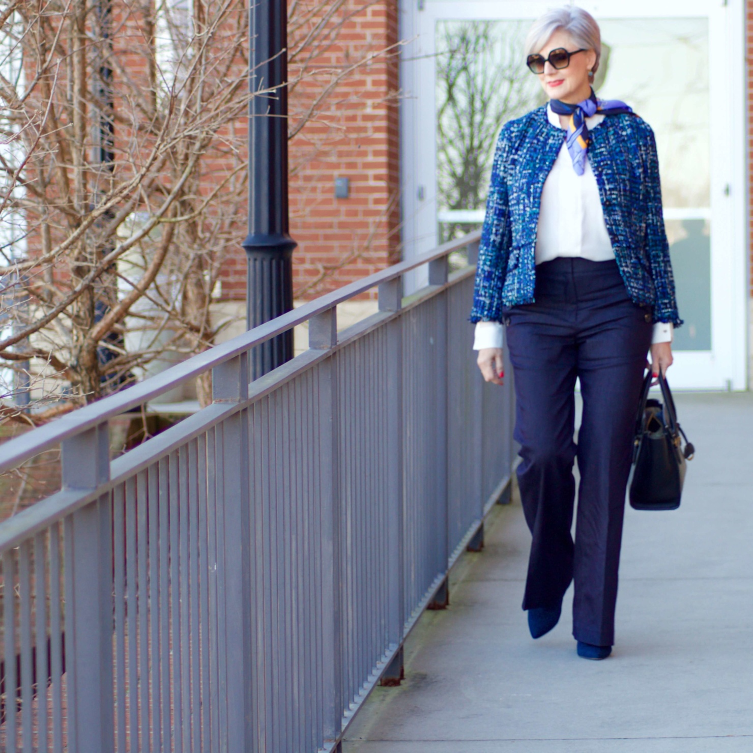 beth from Style at a Certain Age wears an Ann Taylor blue tweed jacket, faux denim sailor pants, v neck button sleeve blouse, silk ribbon chain scarf, and pointy toe booties