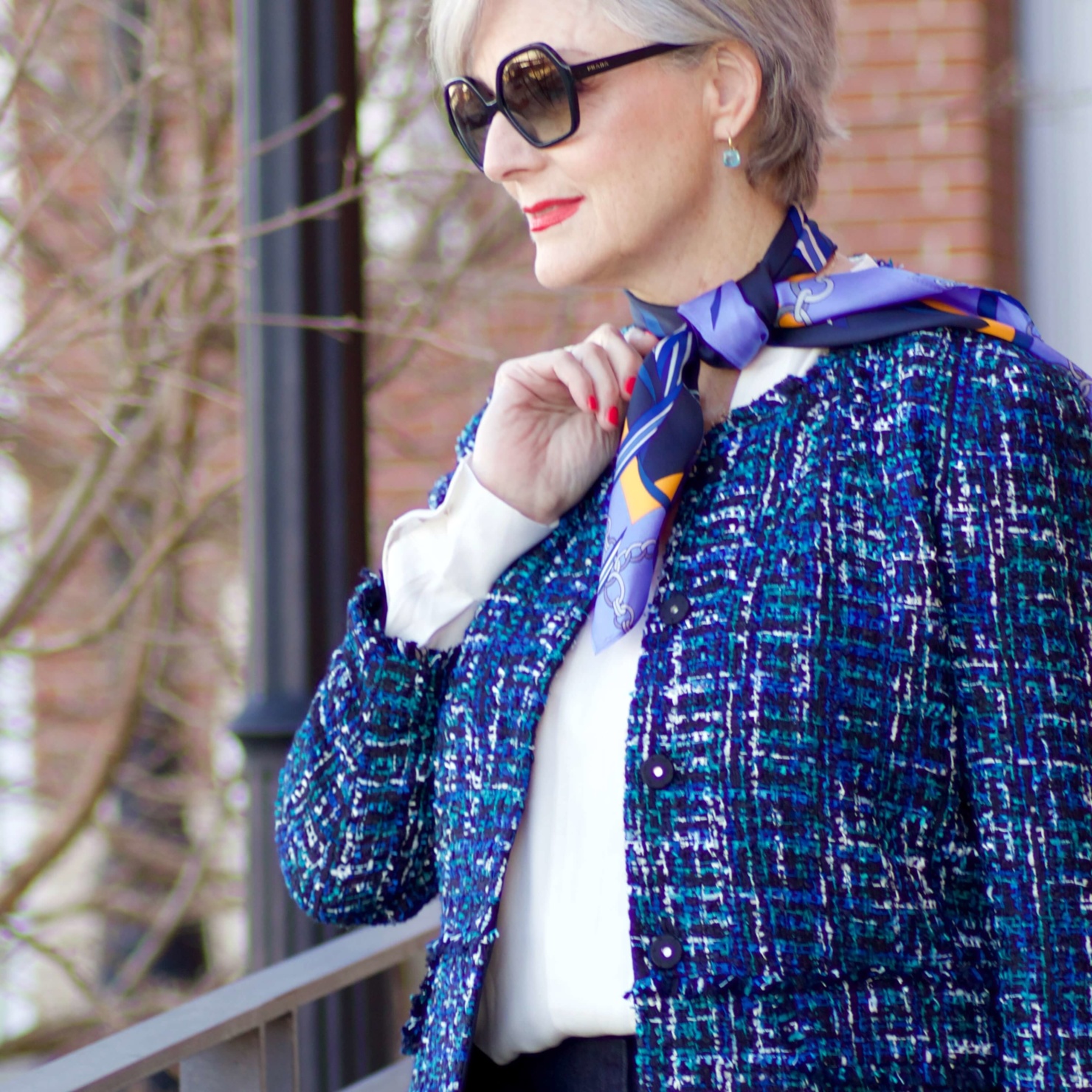 beth from Style at a Certain Age wears an Ann Taylor blue tweed jacket, faux denim sailor pants, v neck button sleeve blouse, silk ribbon chain scarf, and pointy toe booties