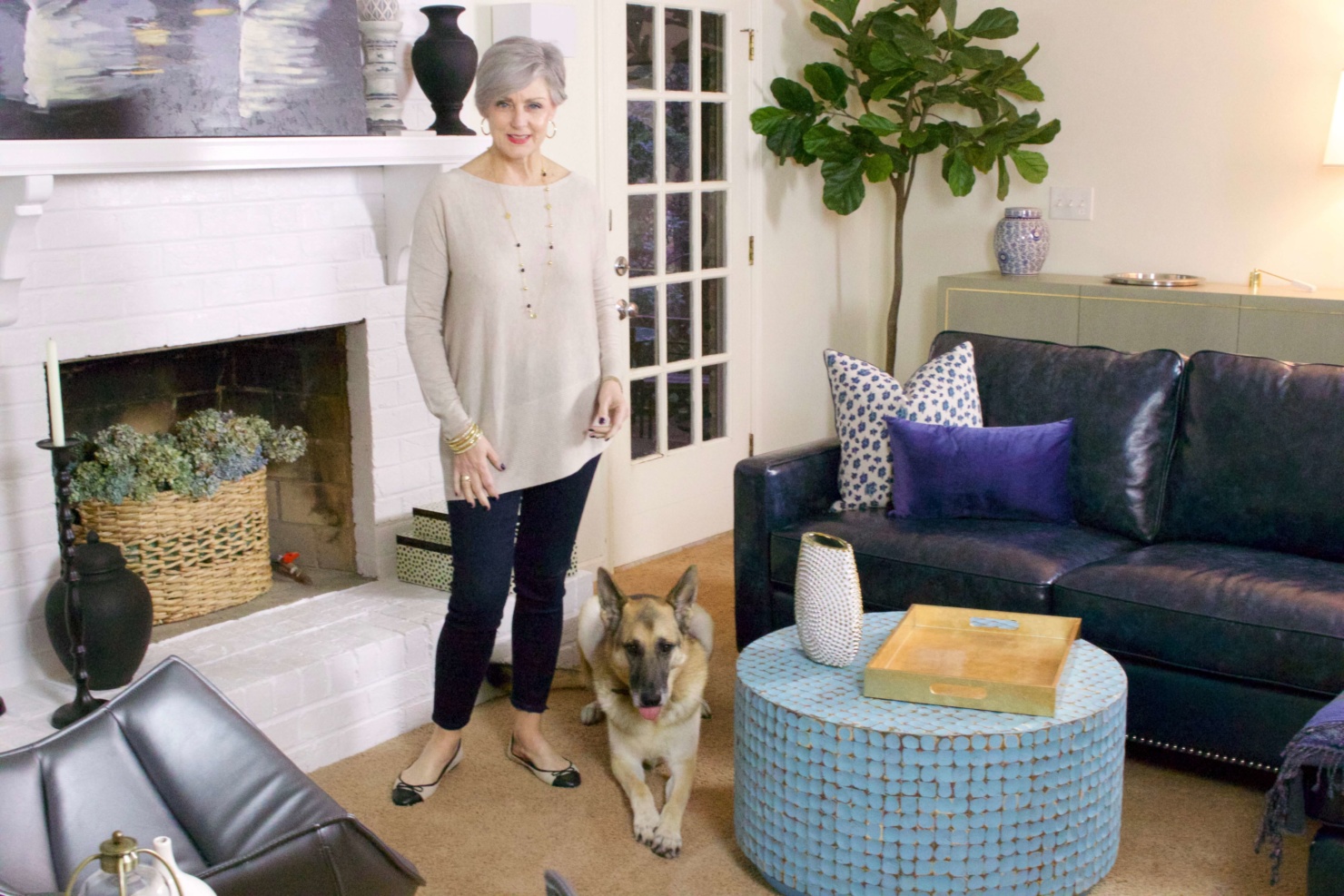 beth from Style at a Certain Age wears an asymmetrical tunic, dark rinse skinny jeans, cap toe ballet flats