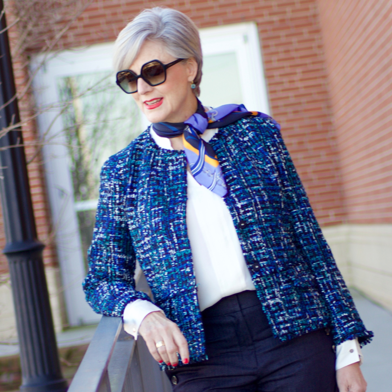 beth from Style at a Certain Age wears an Ann Taylor blue tweed jacket, faux denim sailor pants, v neck button sleeve blouse, silk ribbon chain scarf, and pointy toe booties