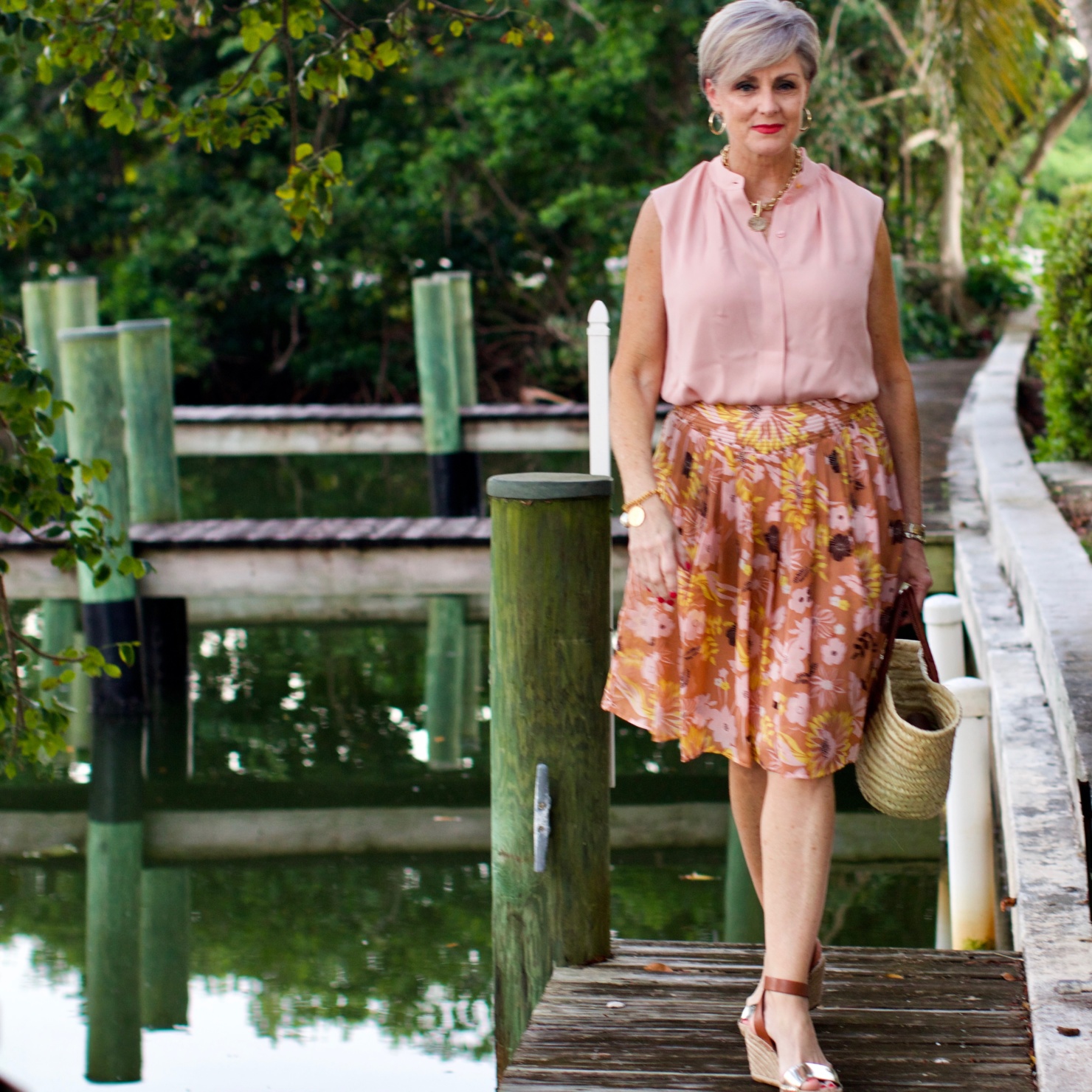 beth from Style at a Certain Age wears a Tory Burch silk blow blouse, silk skirt, and Tory Burch wedges