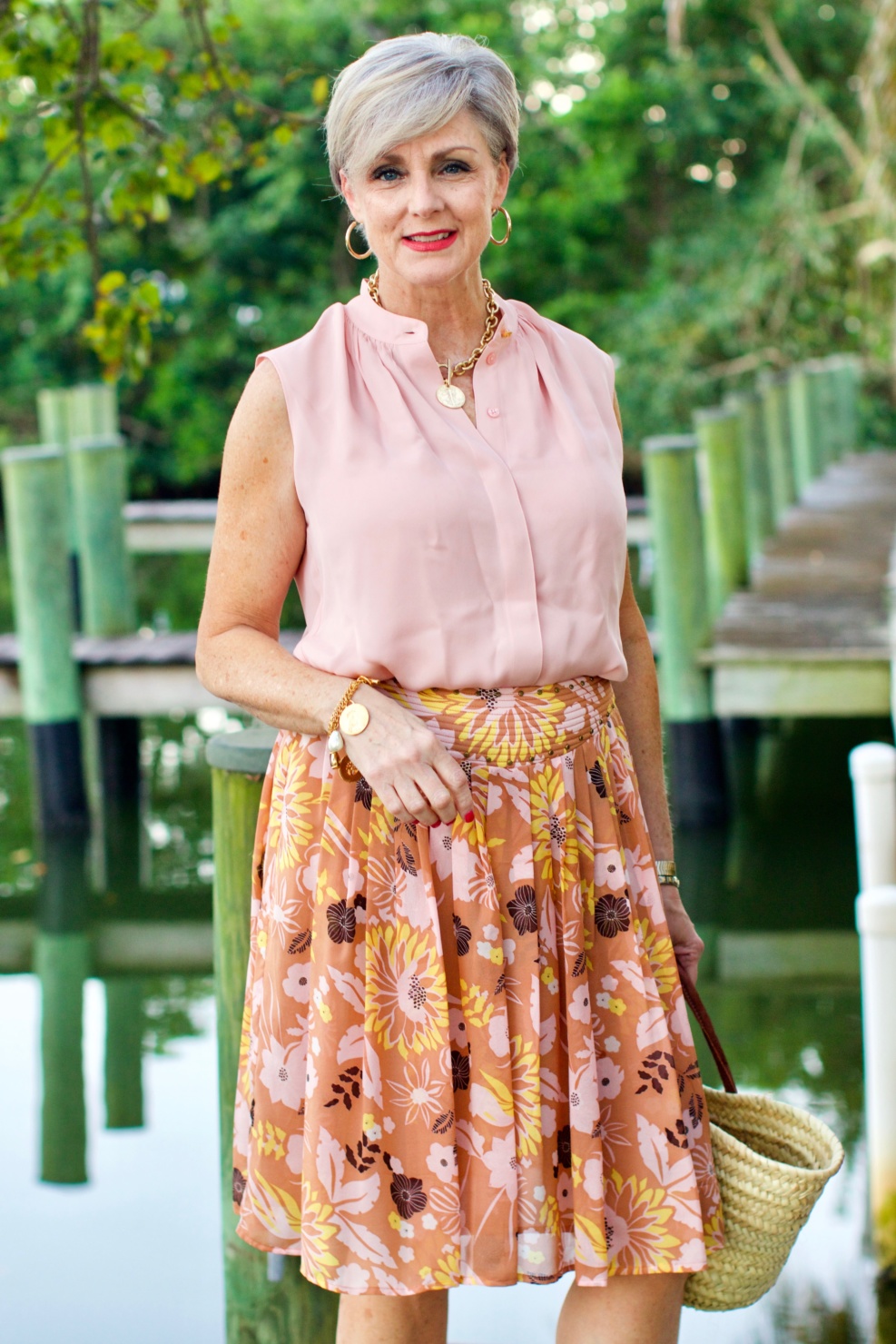 beth from Style at a Certain Age wears a Tory Burch silk blow blouse, silk skirt, and Tory Burch wedges