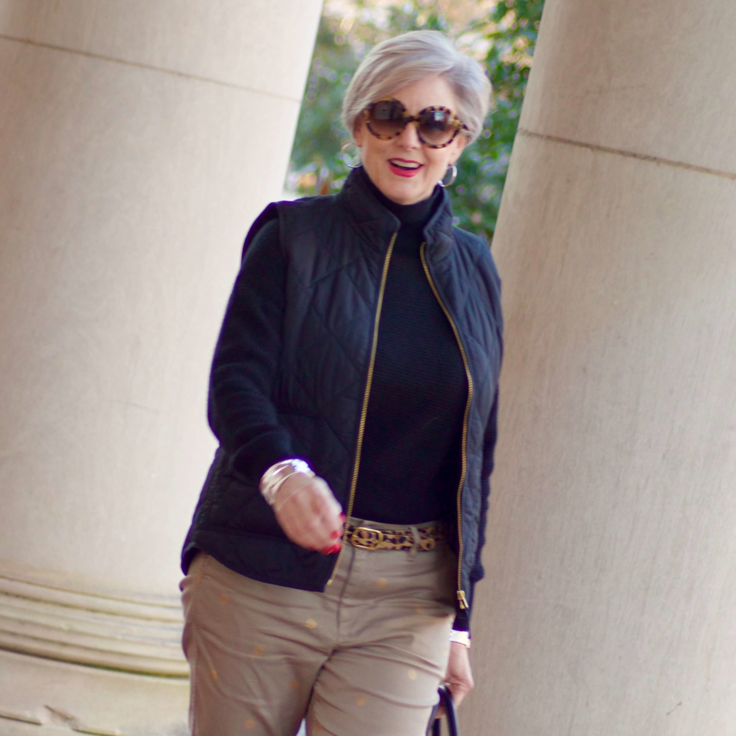 beth from Style at a Certain Age wears J.Crew polka dot chinos, Everlane cashmere waffle turtleneck, J.Crew Factory puffer vest, and Ann Taylor leopard flats