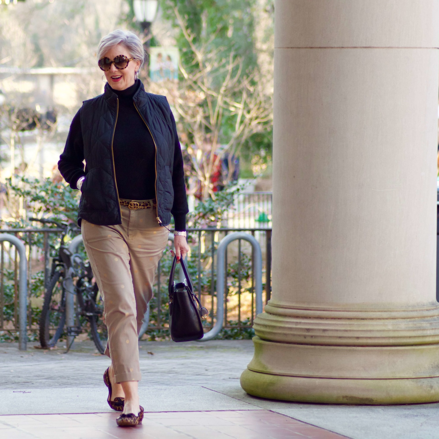 beth from Style at a Certain Age wears J.Crew polka dot chinos, Everlane cashmere waffle turtleneck, J.Crew Factory puffer vest, and Ann Taylor leopard flats