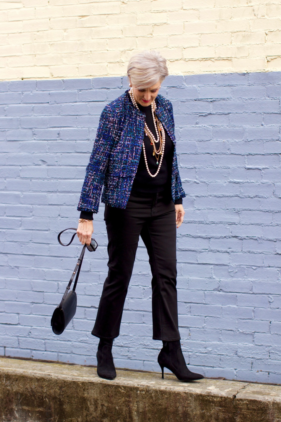 beth at Style at a Certain Age wears an Ann Taylor tweed military jacket, Everlane crewneck cashmere, J.Crew cropped flare denim, pointy-toed boots and strings of pearls