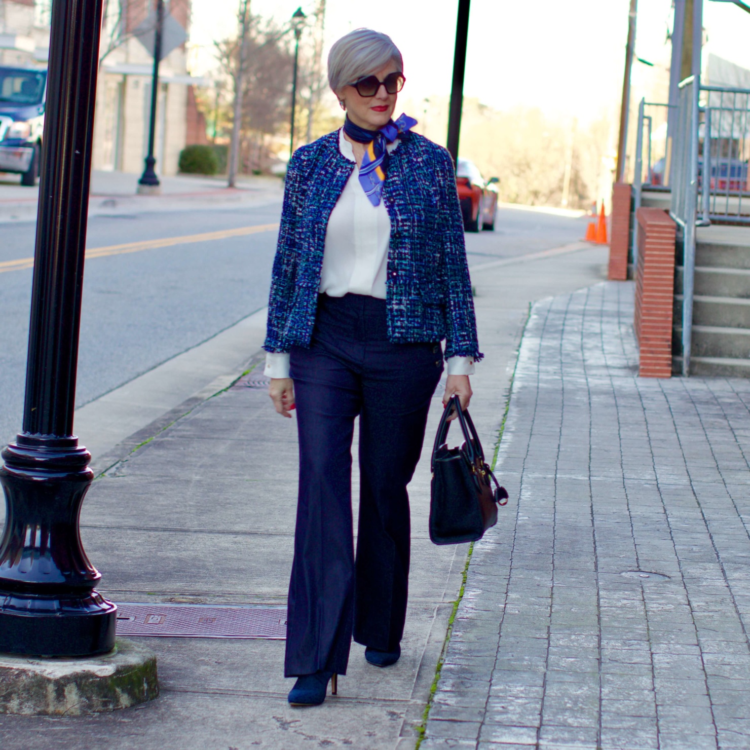 beth from Style at a Certain Age wears an Ann Taylor blue tweed jacket, faux denim sailor pants, v neck button sleeve blouse, silk ribbon chain scarf, and pointy toe booties