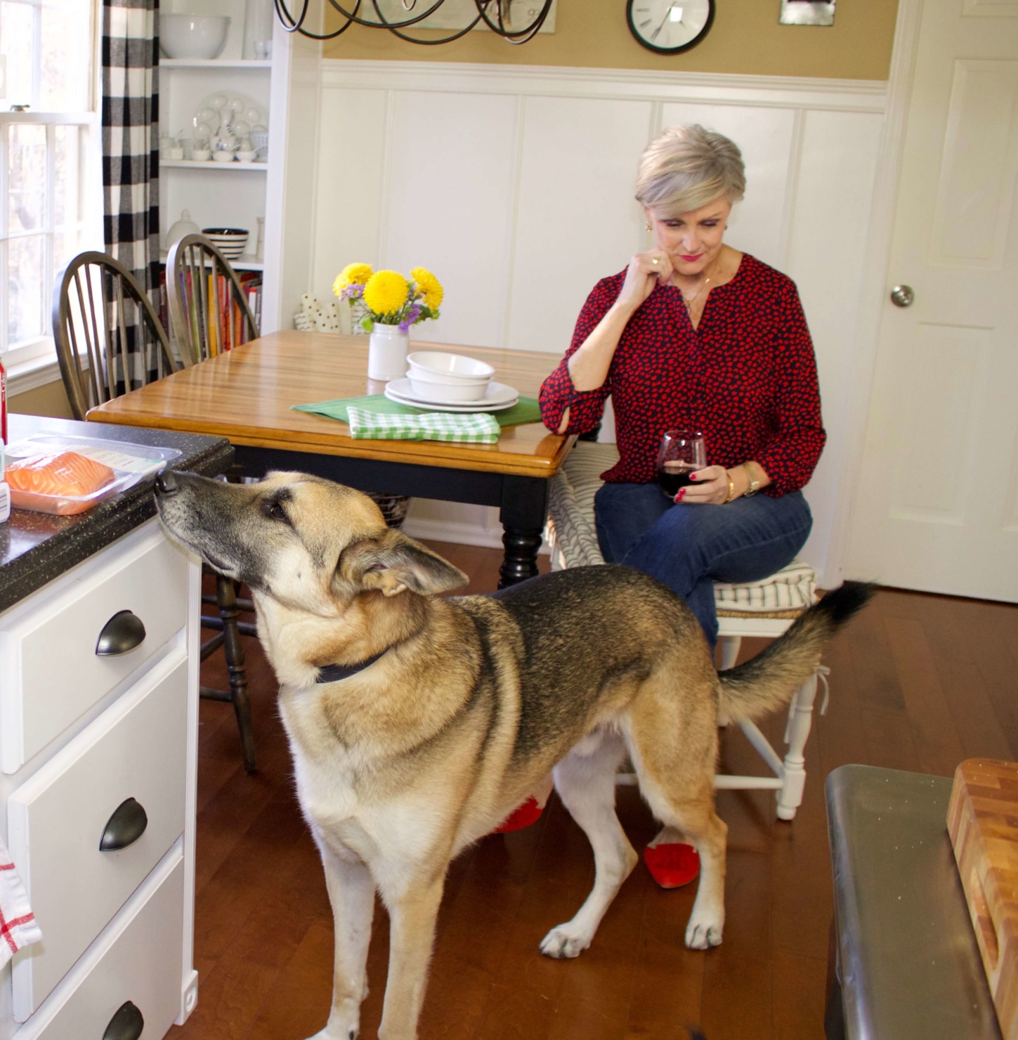 beth from Style at a Certain Age wears a Talbots red heart blouse, girlfriend jeans, and red shoes