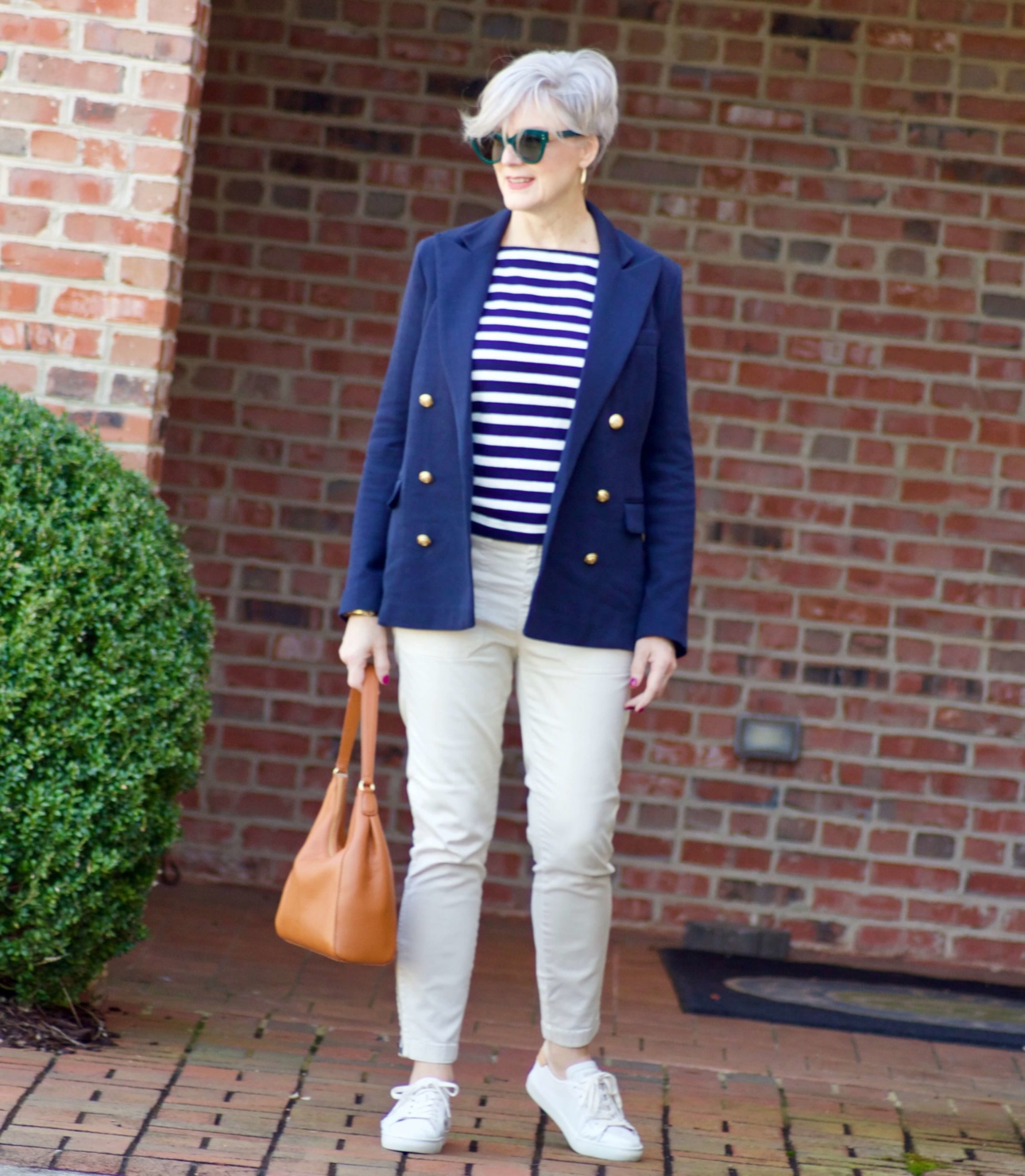 beth from Style at a Certain Age wears J.Crew striped tee, chinos, Ralph Lauren navy blue knit blazer, and white sneakers