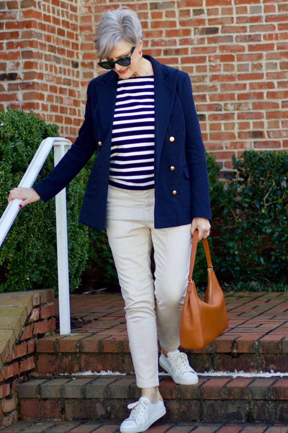 beth from Style at a Certain Age wears J.Crew striped tee, chinos, Ralph Lauren navy blue knit blazer, and white sneakers