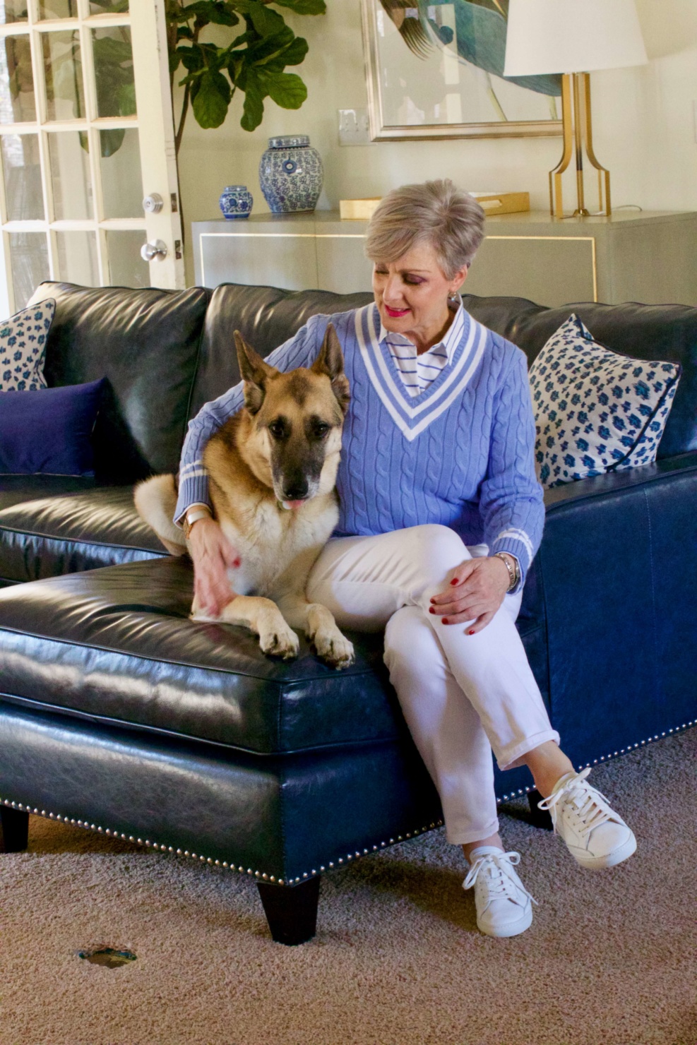 beth from Style at a Certain Age wears a Ralph Lauren cricket sweater, white denim and white tennis shoes