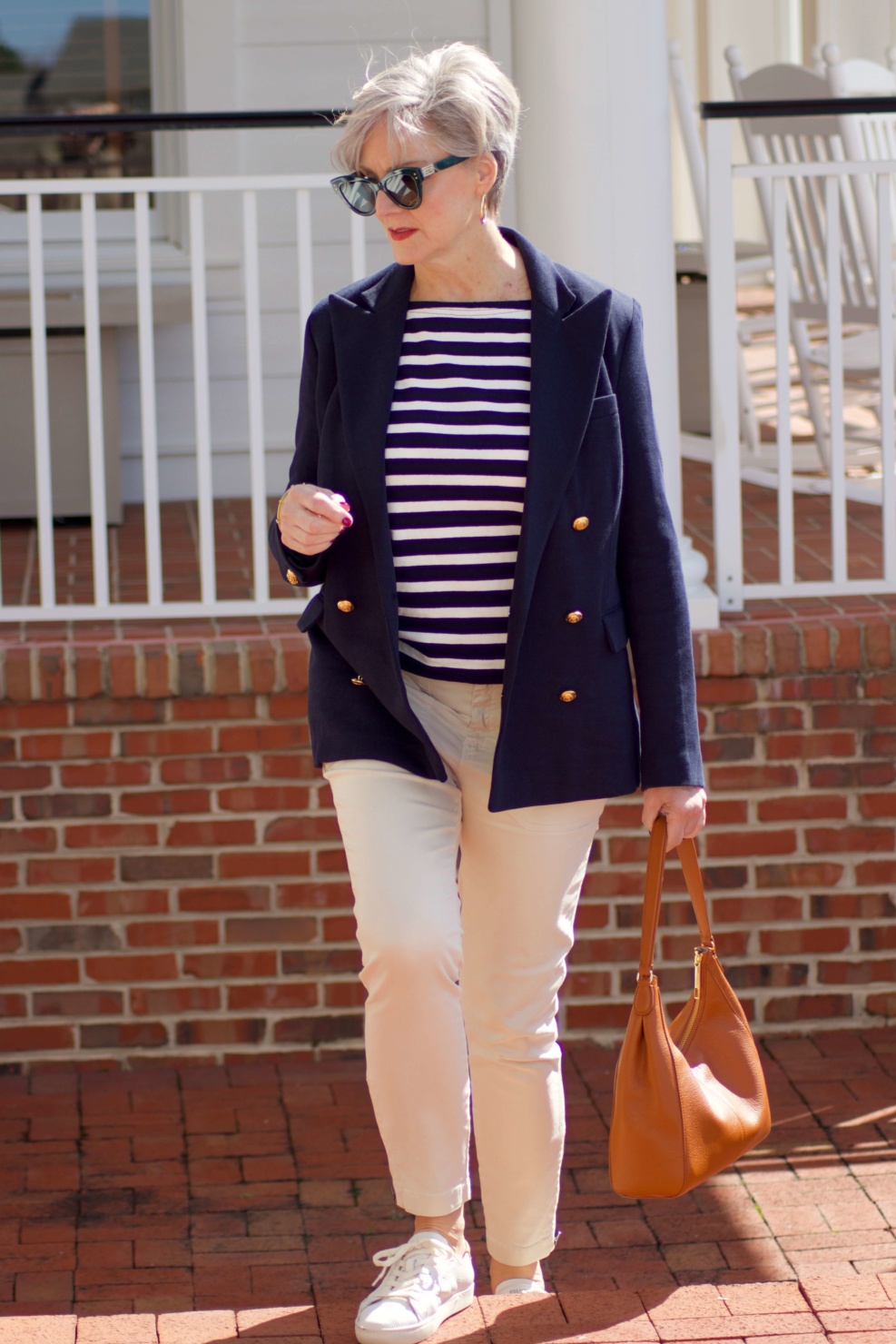 beth from Style at a Certain Age wears J.Crew striped tee, chinos, Ralph Lauren navy blue knit blazer, and white sneakers