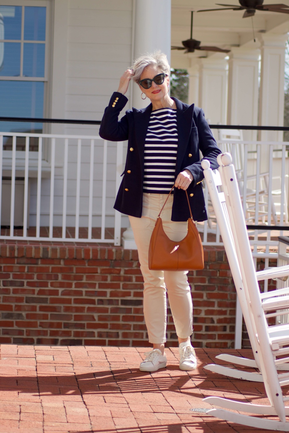beth from Style at a Certain Age wears J.Crew striped tee, chinos, Ralph Lauren navy blue knit blazer, and white sneakers