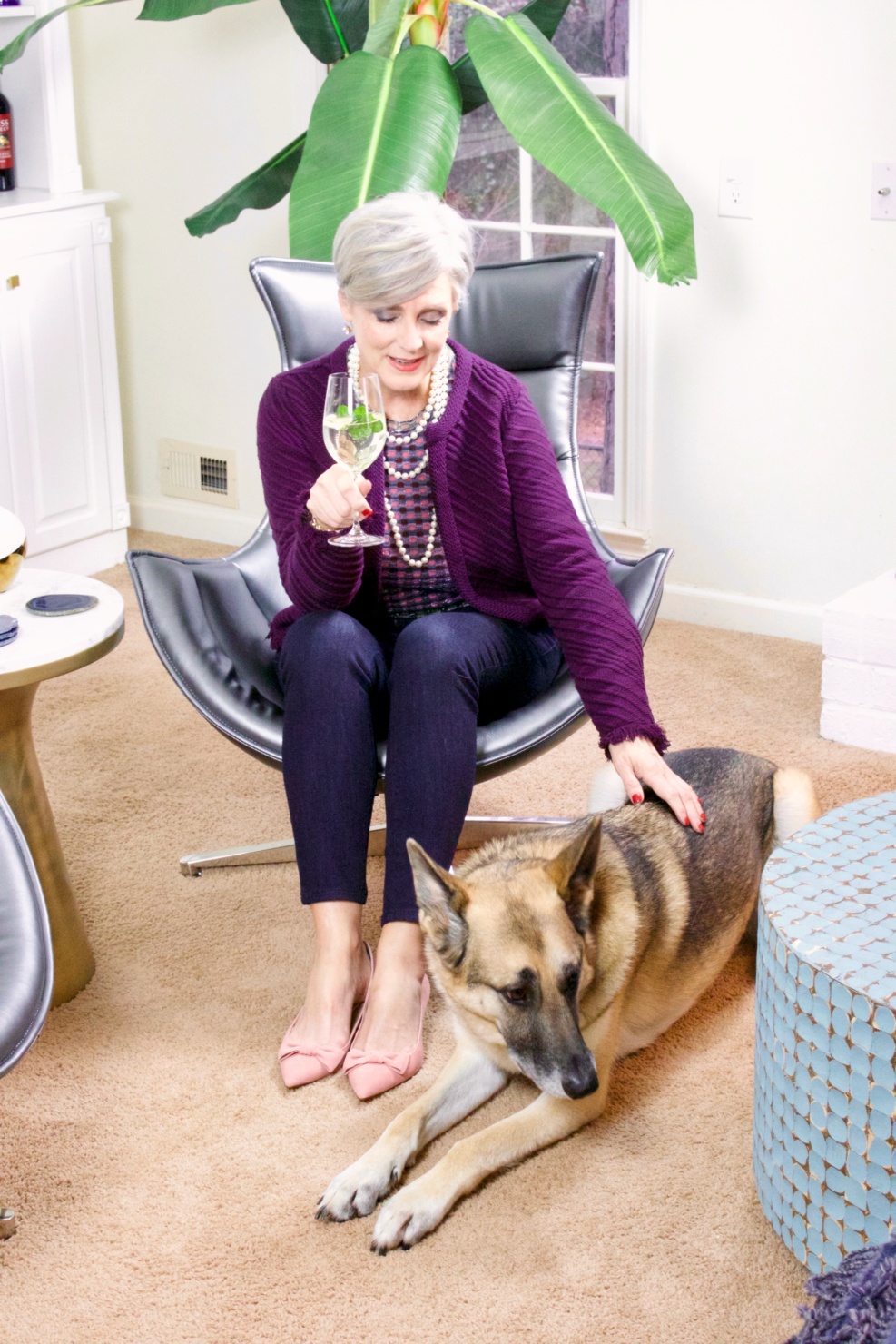 beth from Style at a Certain Age wears a fringed cardigan sweater, denim, and pink suede pumps