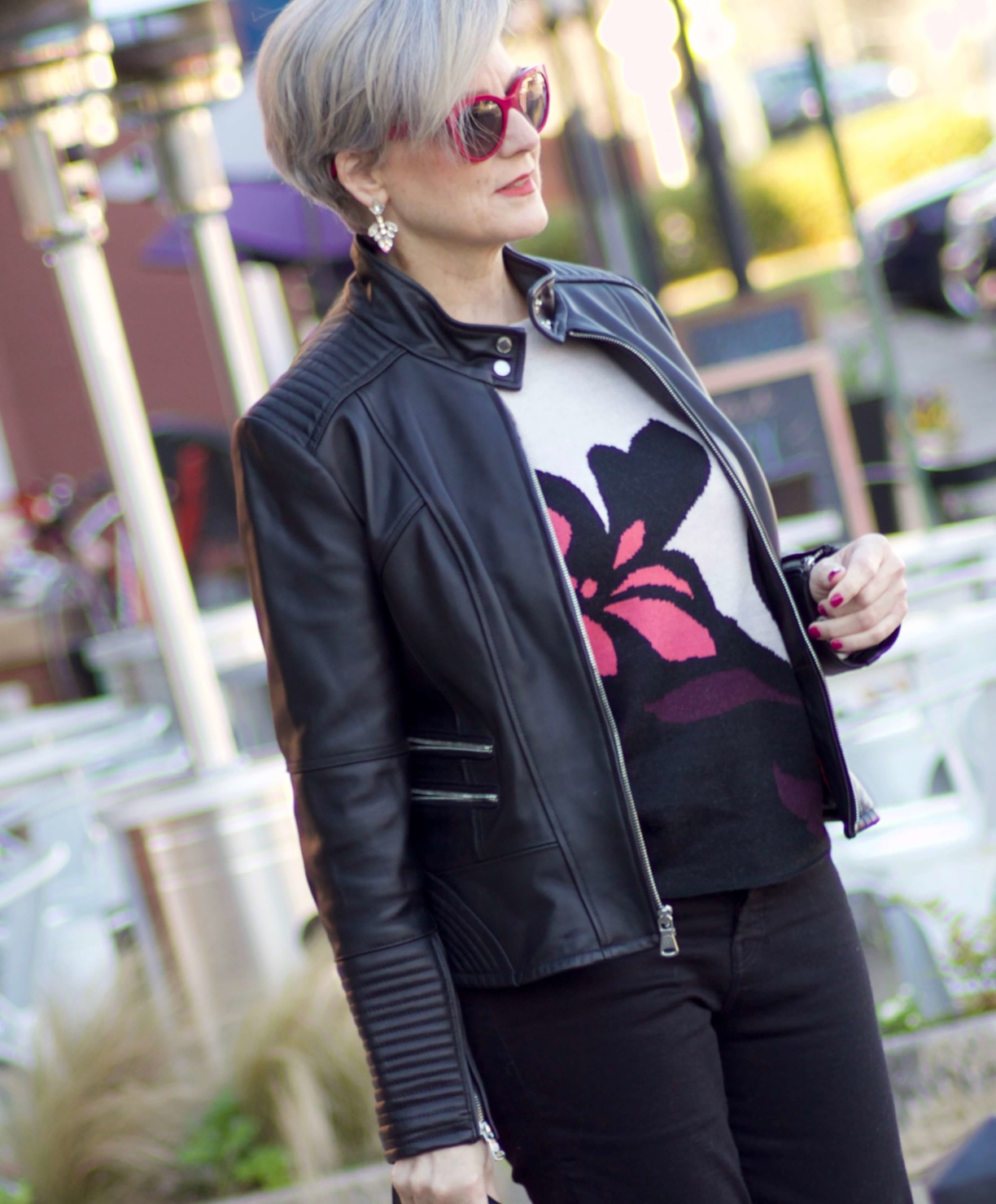 beth from Style at a Certain Age wears a floral jacquard sweater, black skinny jeans, black leather moto jacket and pink suede pumps for date night