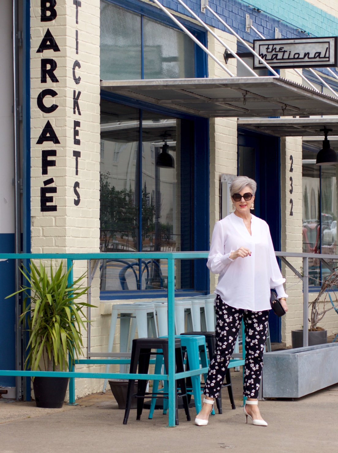 beth from Style at a Certain Age wears an outfit from Lord & Taylor, black pattern pants, white tunic blouse, Sam Edelman shoes
